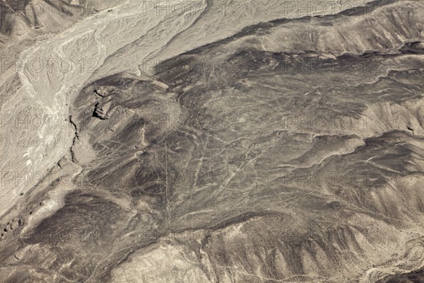 Wide expanse of a barren and dry landscape with eye-catching line patterns, geoglyphs and drawings in the desert near Nasca and Palpa in Peru