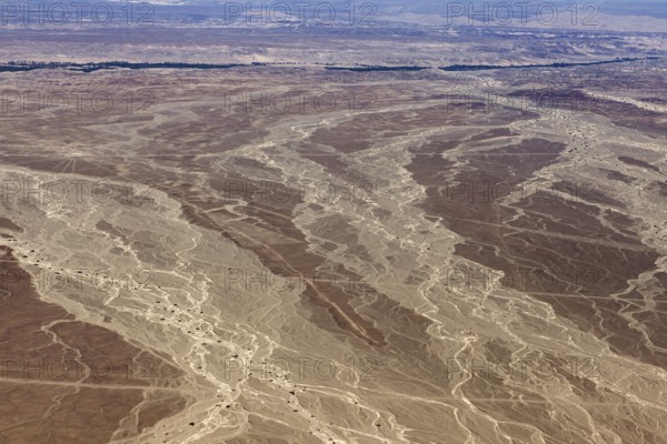 Desert landscape with genetic patterns that criss-cross the soil, the landscape and desert near Nasca in the Andes of Peru