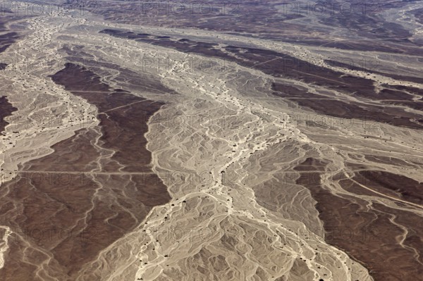 Aerial view of a desert landscape with distinctive sand patterns and lines, The landscape and desert near Nasca in the Andes of Peru