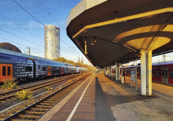 On the train track with a view of the Cologne Triangle skyscraper at sunrise, Deutzer Bahnhof, Cologne, Rhineland, North Rhine-Westphalia, Germany