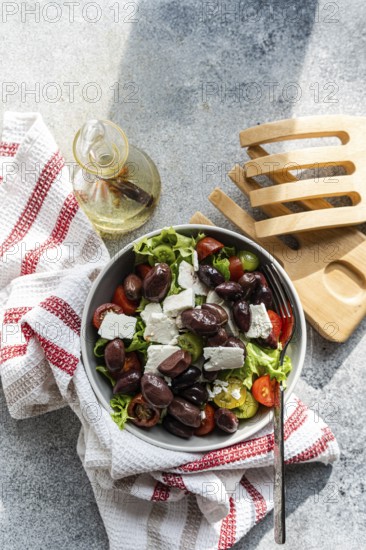 A vibrant Greek salad featuring juicy tomatoes, crisp lettuce, rich feta cheese, and olives, perfect for a refreshing meal