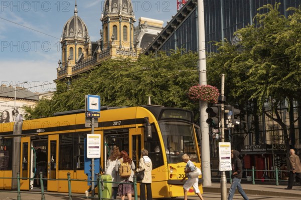 Budapest, Hungary. October 1st 2023 Passengers board a Hungarian city tram outside the Nyugati Palyaudvar rail station in Budapest, Hungary