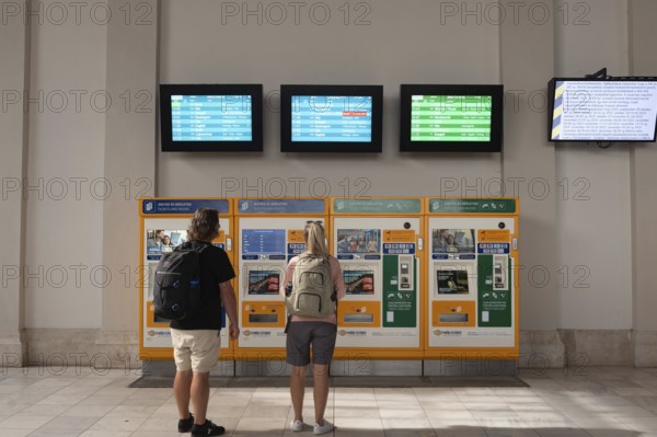 Budapest, Hungary. October 1st 2023 Tourists buying a train tickets from automatic machines at Nyugati Palyaudvar rail station in Budapest, Hungary