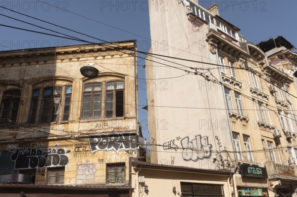 Bucharest, Romania. October 29th 2023. Graffiti covered crumbling architecture of the historical Old town of Bucharest, Romania