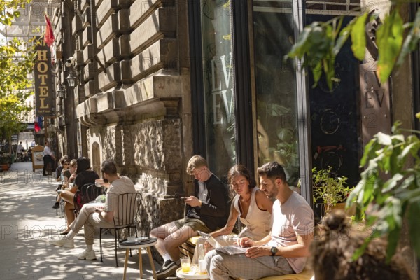 Bucharest, Romania. October 29th 2023. Young people relax outside a popular cafe in Grand Old Town of the Romanian Capital, Bucharest, Romania