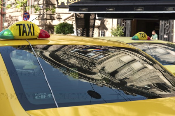 Bucharest, Romania. October 29th 2023. Romanian Taxi cabs parked outside a popular restaurant in the Old Town of Bucharest, Romania