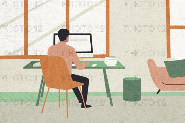 A man sits at a green desk in a light-flooded room, focused on his computer Books are stacked nearby, and comfortable seating adds to the inviting atmosphere