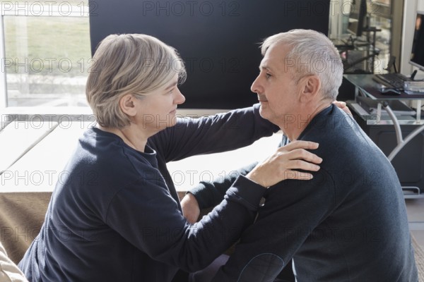 An elderly couple shares an intimate, tender moment in a cozy indoor setting The scene captures love, connection, and warmth, highlighting the beauty of mature relationships