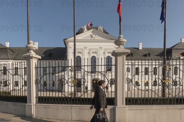 Bratislava, Slovakia. October 3rd 2023 A man walks past the Grassalkovich Palace. The official residence of the President of the Republic of Slovakia