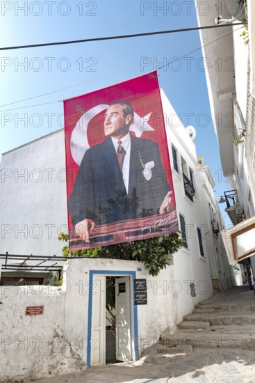 Bodrum, Turkey. April 23rd 2022 A pretty street with traditional local architecture and portrait of Ataturk in the lanes of Bodrum Old Town, Turkish Aegean Coast, Turkey