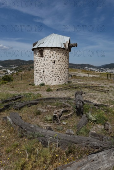 One of the partially restored Bodrum Windmills, overlooking Gumbet bay and Bodrum Marina, a local landmark the windmills are damaged and derelict. southern Aegean Region, Turkey