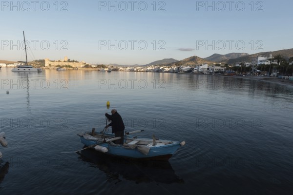 Bodrum, Mugla, Turkey. April 21st 2022 A fisherman at dawn in the beautiful harbour of Bodrum on the Turkish southwest coast of the Aegean Sea, Turkey