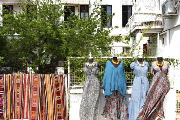 Bodrum, Mugla, Turkey. April 21st 2022 Colourful carpets and pretty dresses for sale on the street in popular tourist destination Bodrum on the south west coast of Turkey