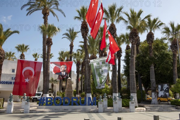 Bodrum, Mugla, Turkey. April 21st 2022 Hash Tag Bodrum city centre sign under Turkish flags and portrait of Ataturk, a popular harbour seaside tourist destination beside the Aegean in south western Turkey