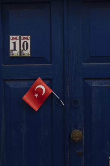 Bodrum, Mugla, Turkey. April 23rd 2022 A pretty blue door with a Turkish flag in the charming side streets of the Aegean seaside city of Bodrum, south west Turkey