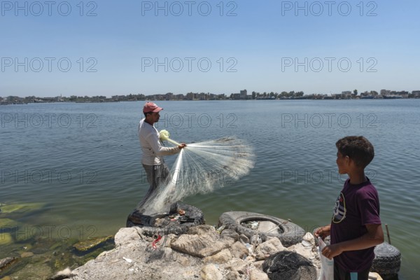 Rosetta, Egypt. June 27th 2024 A local Egyptian fishermen castes his weighted net into the River Nile at Rosetta in the Nile Delta in Northern Egypt