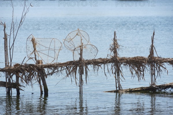 Reed fish traps and metal cages a typical method of fishing along the River Nile at Rosetta in the Nile Delta of North Egypt