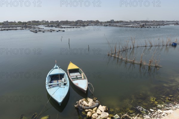 Small fishing boats and fish traps near the fish farms of Rashid on the River Nile, Rosetta, Egypt