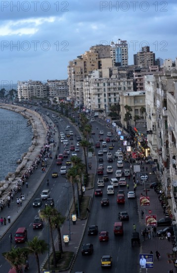 Old high rise buildings overlooking the busy Corniche of Alexandria's Mediterranean Sea front, Alexandria, Egypt