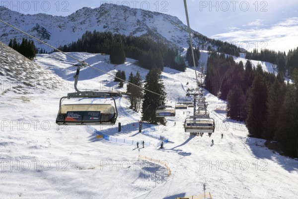 Sun and good snow conditions in the Oberjoch ski area in the Allgäu region. View of the slopes from the chairlift