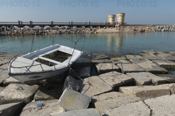 Alexandria, Egypt. December 1st 2022 A boat on concrete blocks positioned as a defence against rising sea levels along the Corniche of Alexandria, the seconds largest city in Egypt