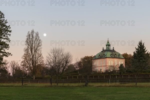 Full moon over the pheasant castle in Moritzburg at sunrise, Saxony, Germany