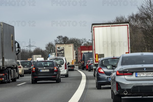 Driving on the A57 motorway, at the Kamp-Lintfort interchange, 3 lanes, traffic jam due to construction site, North Rhine-Westphalia, Germany
