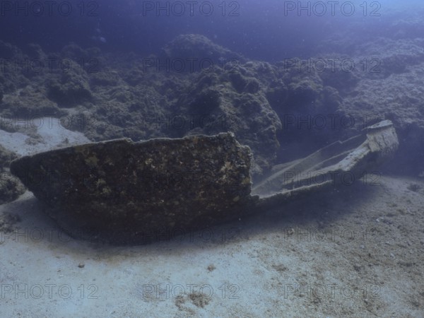 An underwater shipwreck in a dark, rocky environment. Fraskeric dive site, Stoja, Pula, Croatia, Mediterranean