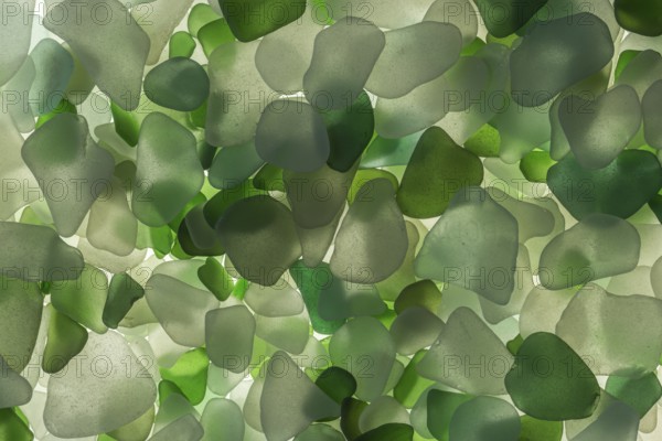 White and green broken glass cut by the sea, sea glass, sea glass, beach glass from the North Sea