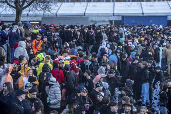 Banks of the Rhine on the old town, despite rainy weather, many, mostly young people gather here to celebrate on Rose Monday in Düsseldorf, North Rhine-Westphalia, Germany