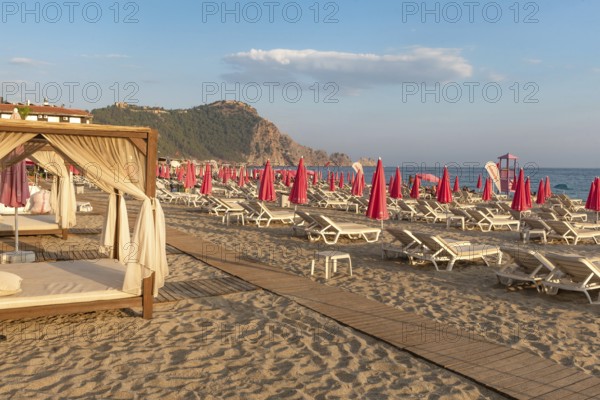 Alanya, Turkey. July 9th 2024 Sunbeds and pink sunshades on Cleopatra Beach in the Turkish holiday resort town of Alanya on the Mediterranean coast of Turkey, the Turkish Riviera