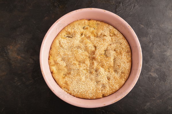 Apple Charlotte cake in baking dish on black concrete background, top view, flat lay, close up