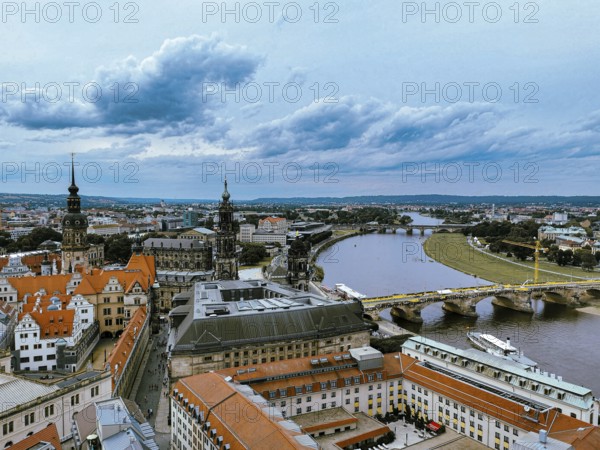 Panoramic view of Dresden with river and historic architecture under dramatic sky, Dresden