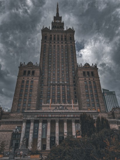 Dominant Palace of Culture in Warsaw against a dramatically cloudy sky with neoclassical style elements, Warsaw, Poland