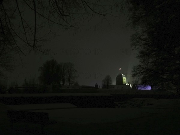 Dark, silent night scene with the dimly lit Rosenberg Fortress behind the trees, Kronach, Frankenwald nature park Park