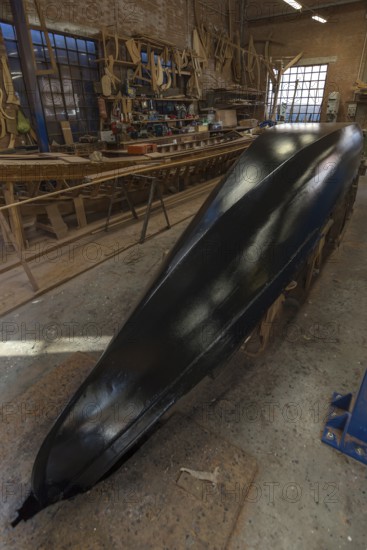 Freshly lacquered hull of a gondola in a shipyard on the island of Giudecca, Veneto, Italy