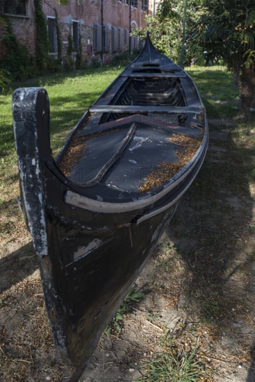 Old gondola in a garden, Giudecca Island, Veneto, Italy