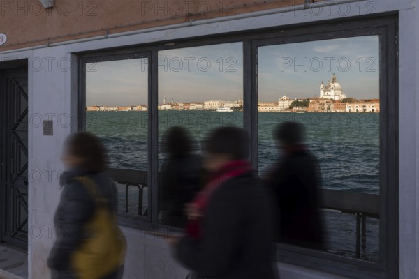 Santa Maria della Salute is reflected in a shop window on the island of Giudecca, Venice, Veneto, Italy