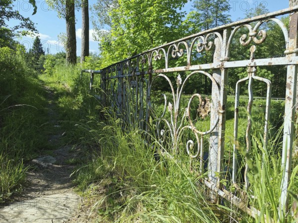 An old, rusty iron fence along a grassy path, Upper Franconia