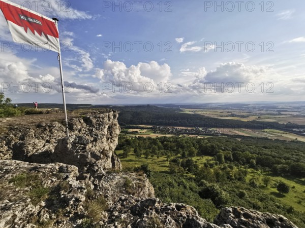 Franconian flag flies on Staffel Mountain, with a wide view over the lowlands and sky, Frankenwald nature park Park
