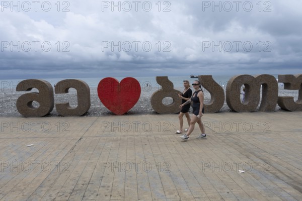 Batumi, Georgia. July 21st 2025. Tourists walking along the seaside esplanade near Batumi Port on the Black Sea coast of Georgia