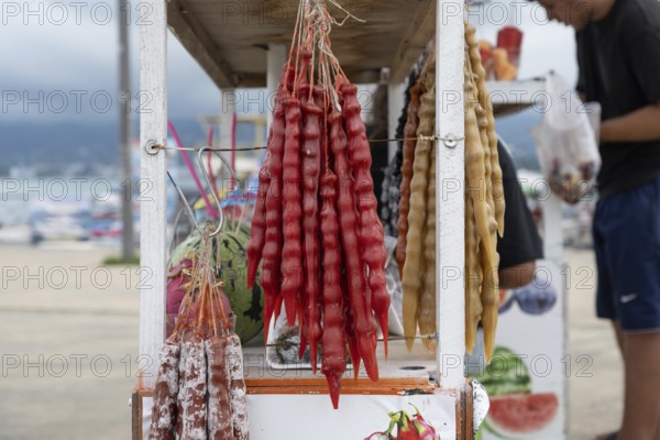 Batumi, Georgia. July 21st 2025. A street stall selling Churchkhela, a popular sweet snack made of nuts threaded on string and dipped in grape juice which dries into gelatin like coating