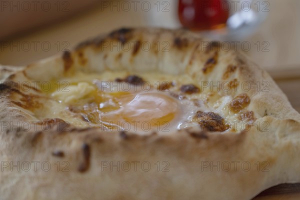 Acharuli-Ajarian Khachapuri, the most popular street food in Georgia, a famous breakfast dish made of a boat shaped baked bread, cheese and egg