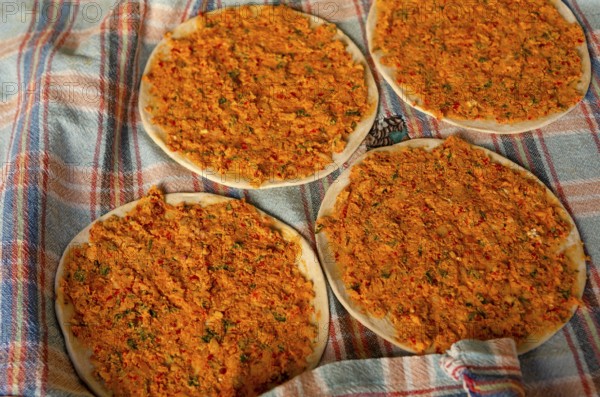 Traditional Turkish Biberli Ekmek Flat bread with red pepper paste being prepared before cooking in Antakya Hatay, Turkey