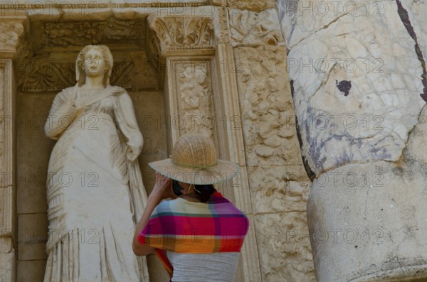 Ephesus, Turkey. July 2nd 2015 A foreign tourist takes a photogaph of a Greek statue at Ephesus, Turkey