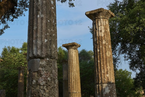 Palestra, tall, ancient columns against a bright blue sky, Archaeological Site, Ancient Olympia, Olympia, Peloponnese, Greece