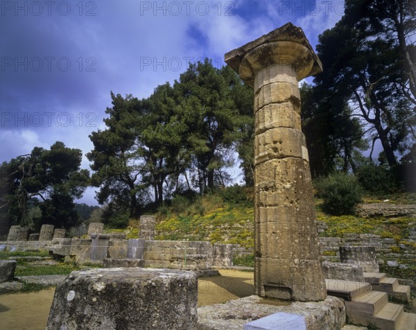 Hera Temple, Temple of Hera, Heraion, Single tall pillar in a natural setting under cloudy sky, Archaeological Site, Ancient Olympia, Olympia, Peloponnese, Greece