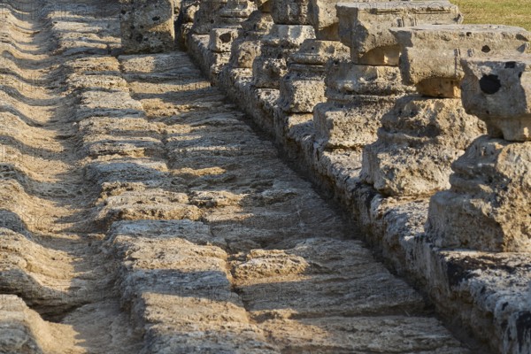 Set of ancient stones with long shadows showing detail, Archaeological Site, Ancient Olympia, Olympia, Peloponnese, Greece