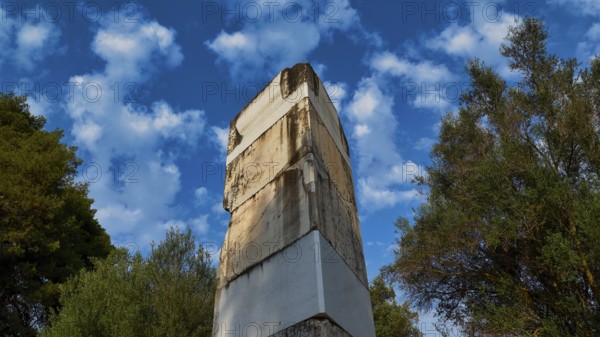 Ancient wall against cloudy sky and surrounded by trees, Archaeological Site, Ancient Olympia, Olympia, Peloponnese, Greece