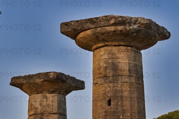 Temple of Hera, Temple of Hera, Heraion, Two ancient stone pillars against a clear blue sky, Archaeological Site, Ancient Olympia, Olympia, Peloponnese, Greece